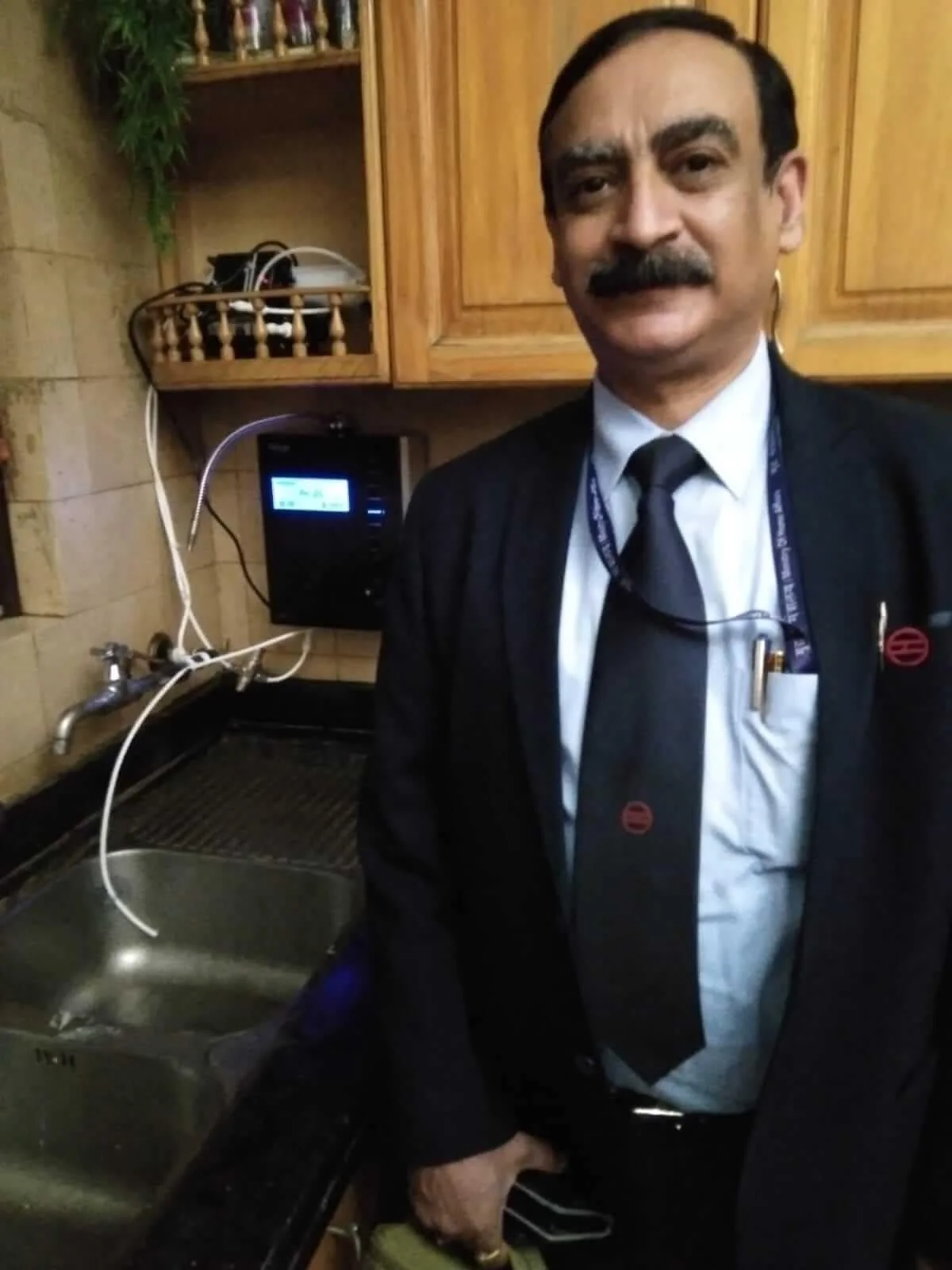 Male customer utilizing Chanson Quality Water Purifier for daily hydration