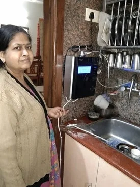 Female customer happily engaged with the Chanson Quality Water Purifier