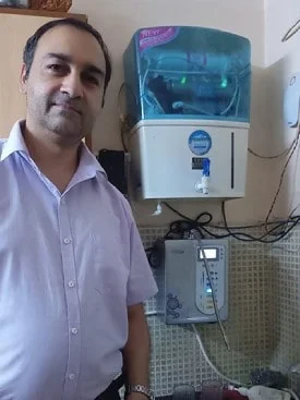 Satisfied male customer with his Chanson Quality Water Purifier