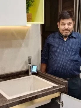 Male customer utilizing Chanson Quality Water Purifier for daily hydration