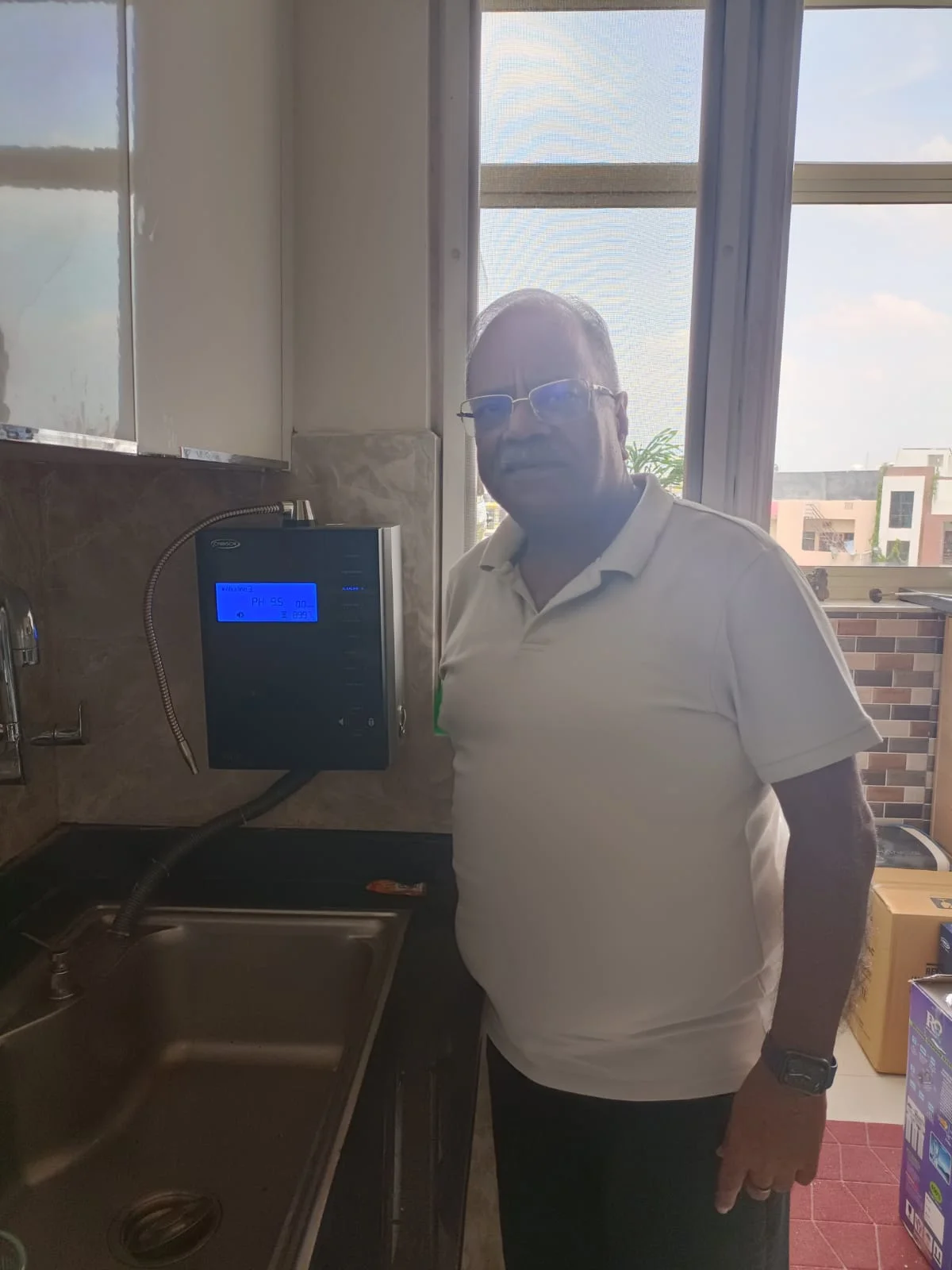Man operating the advanced Chanson Quality Water Purifier in his home