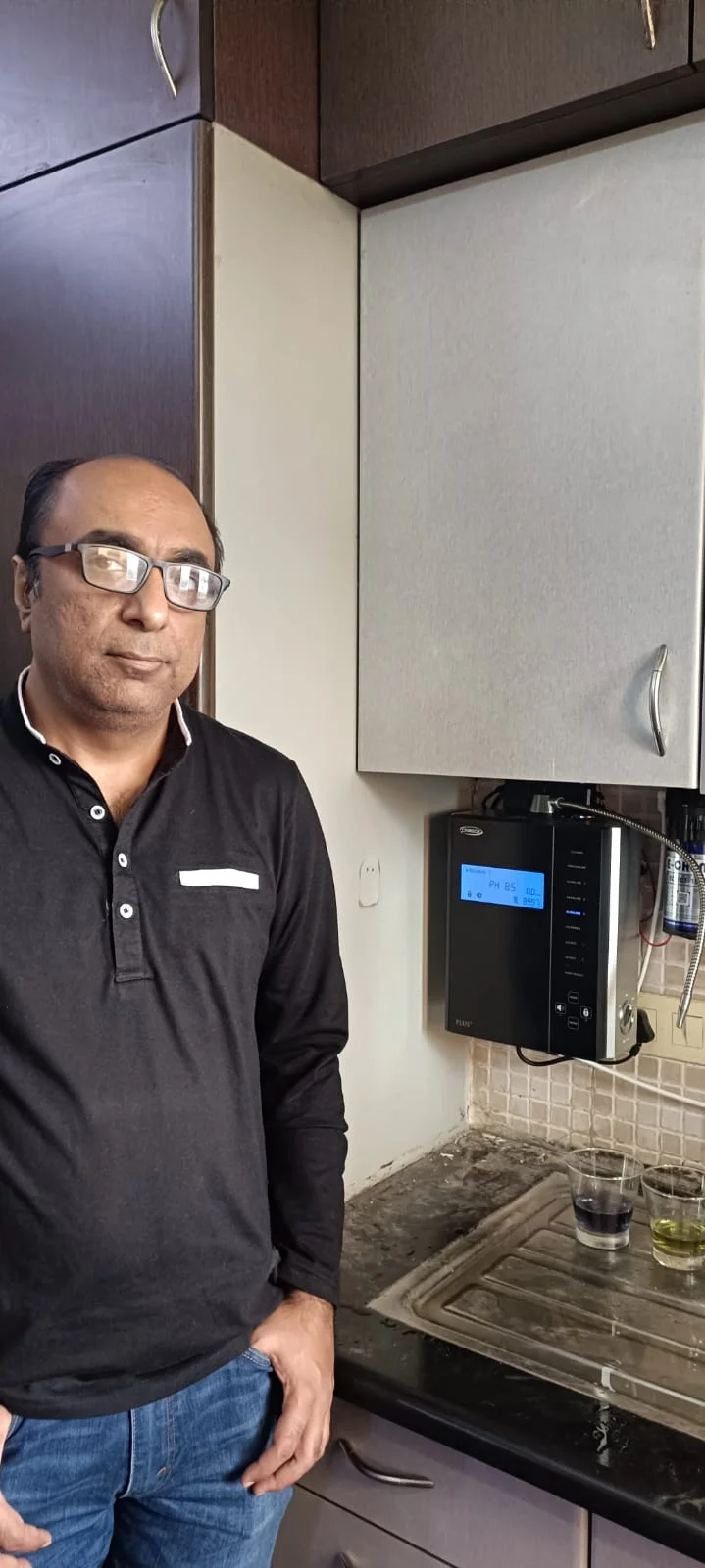 Man relishing the taste of water from his Chanson Quality Water Purifier