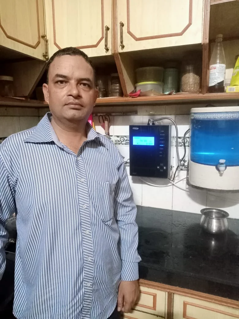 Man at home with his Chanson Quality Water Purifier